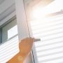 woman hand opens a pvc window with roller