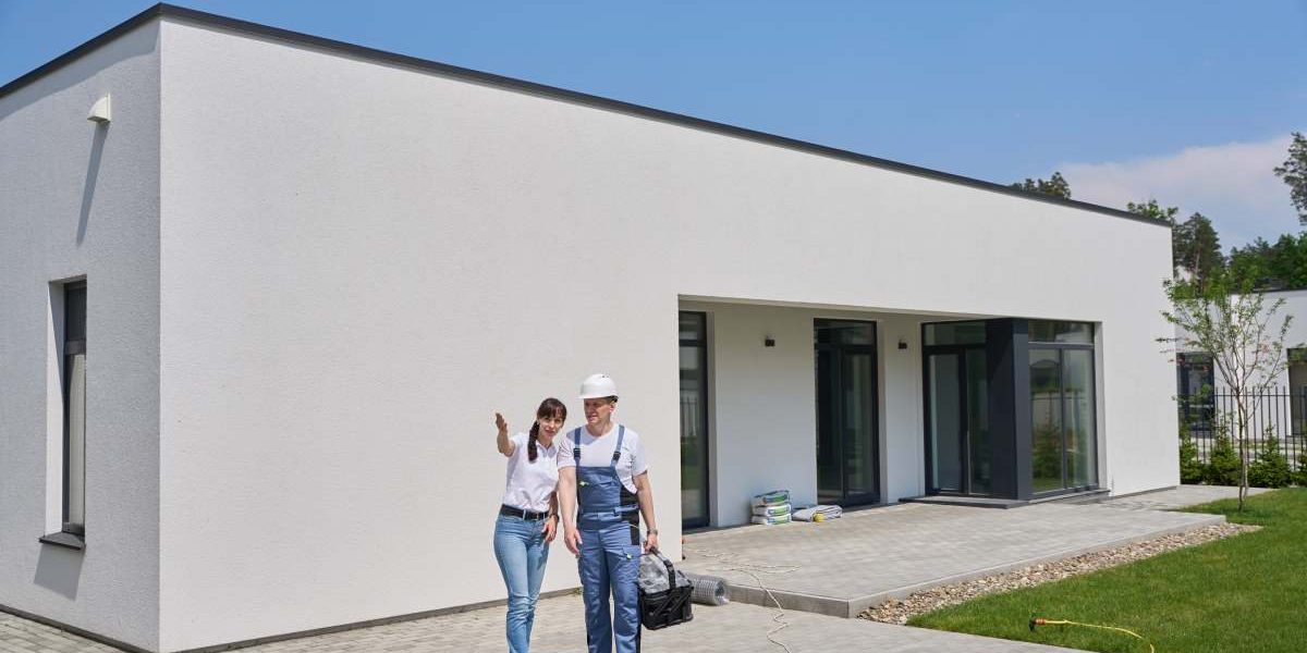 Woman showing something to repairman while they standing by empty swimming pool before repair near new modern townhouse in warm summer day