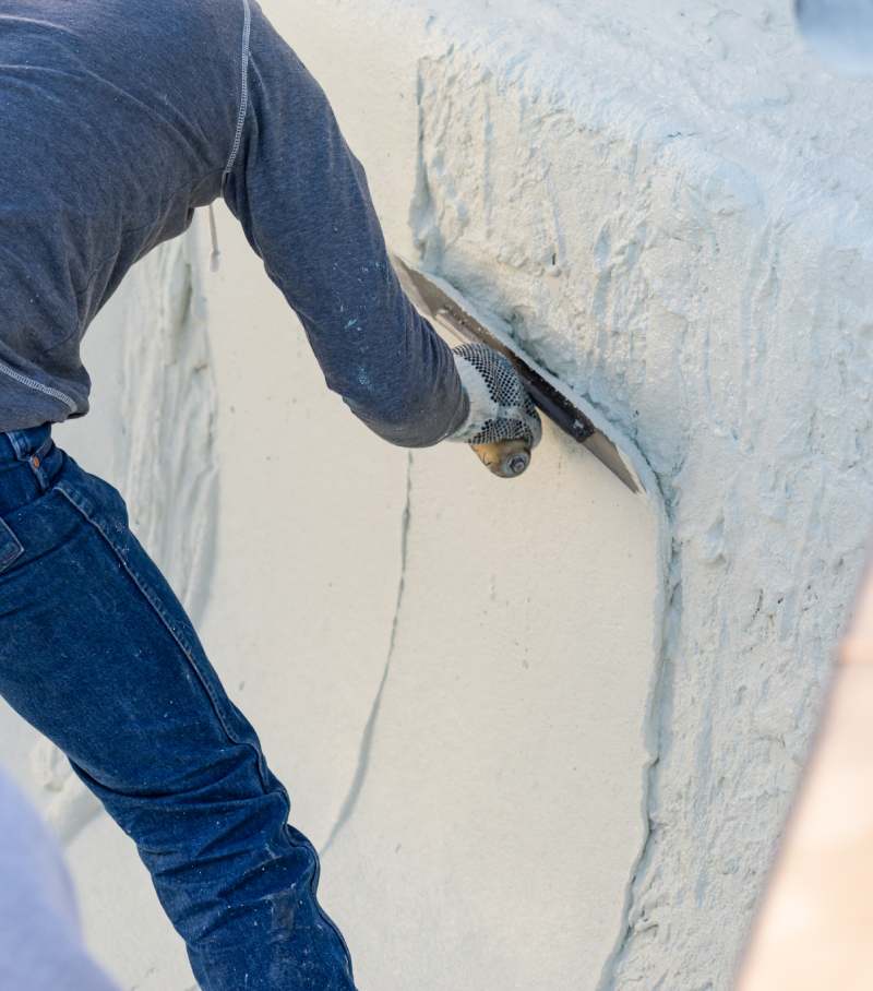 Worker Smoothing Wet Pool Plaster With Trowel.