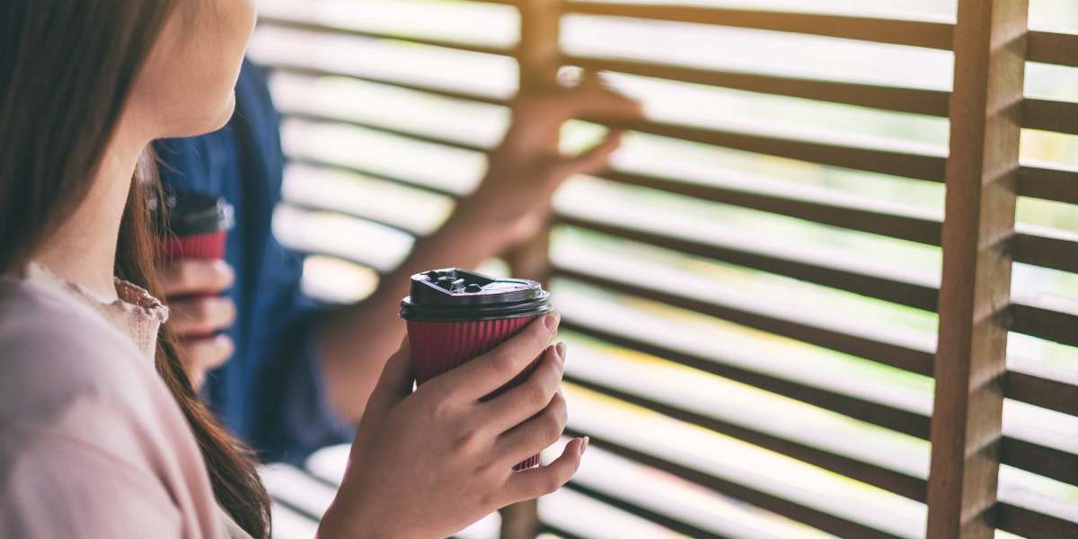 A man and a woman drinking coffee together