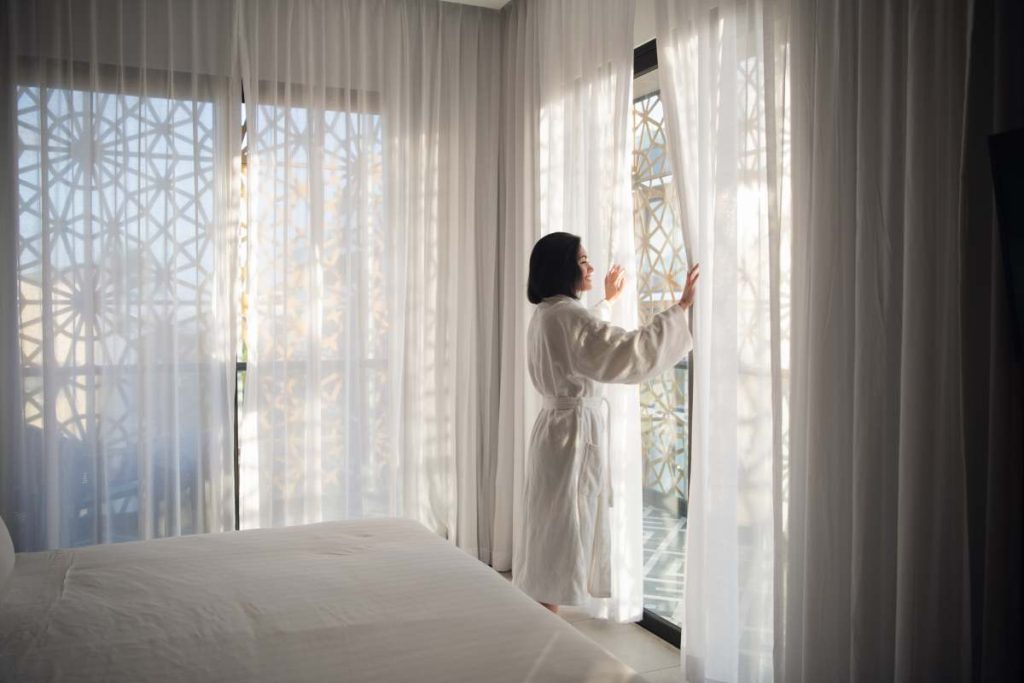 Morning of beautiful young woman near window.