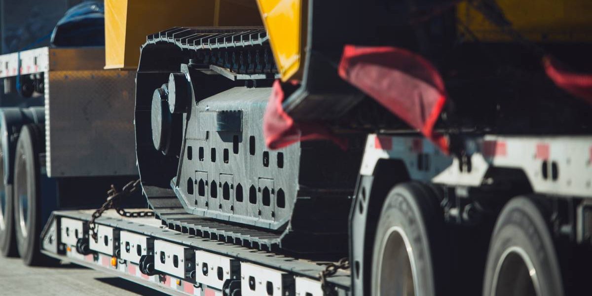 Long Haul Heavy Duty Construction Transport an Excavator on a Semi Truck Trailer. Excavator Delivery.