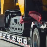 Long Haul Heavy Duty Construction Transport an Excavator on a Semi Truck Trailer. Excavator Delivery.