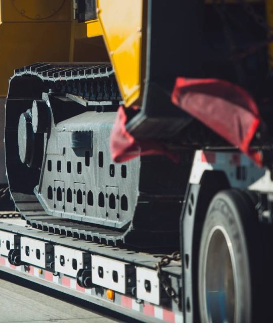 Long Haul Heavy Duty Construction Transport an Excavator on a Semi Truck Trailer. Excavator Delivery.