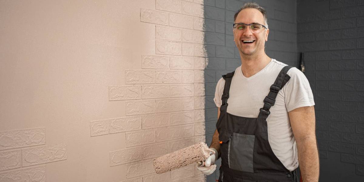 Man Painting Brick Wall in Overalls