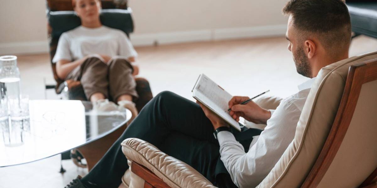 Woman is sitting in chair at an appointment with a Therapy psychologist
