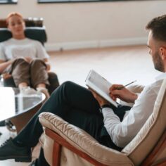 Woman is sitting in chair at an appointment with a Therapy psychologist